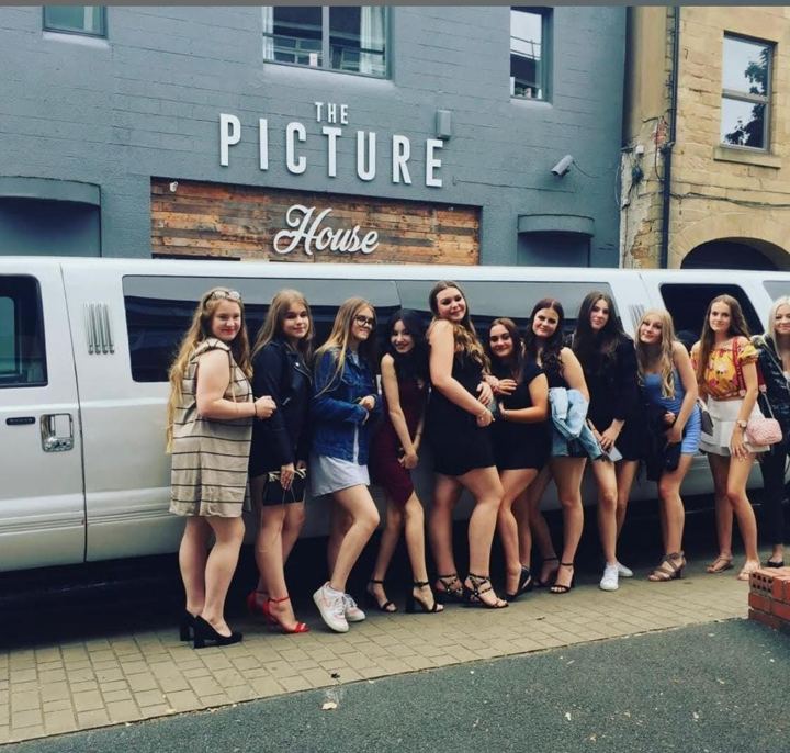 Group of friends on a night out beside a white limo, Nelson