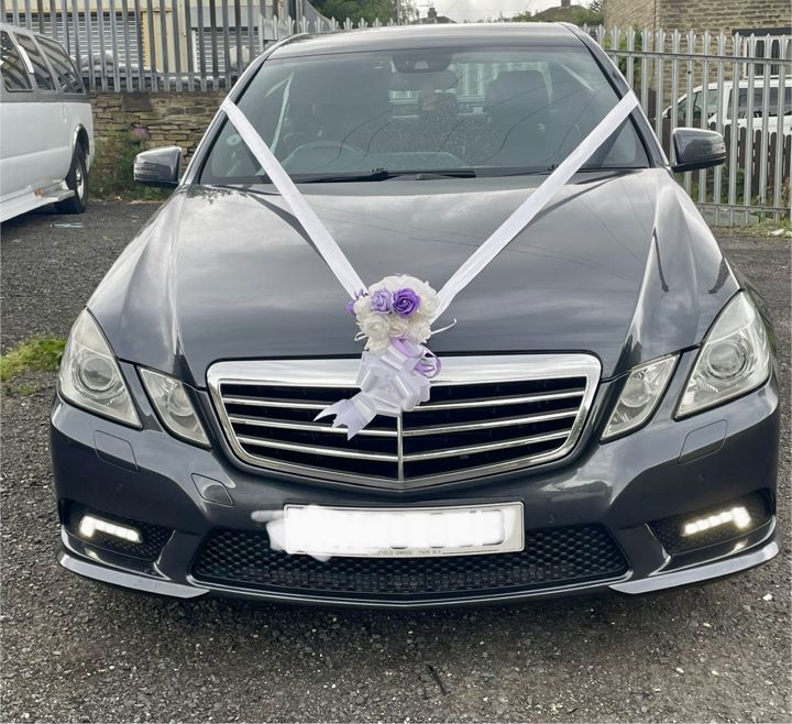 Mercedes E-Class wedding car with ribbon and flowers, London