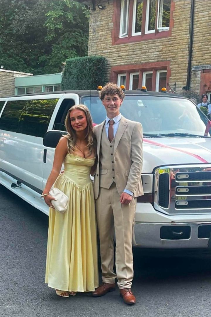 Prom couple in front of a white stretch limo, Manchester