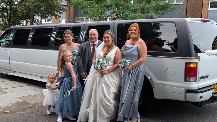 Bride and bridesmaids with a white Ford Excursion wedding limo, Leeds