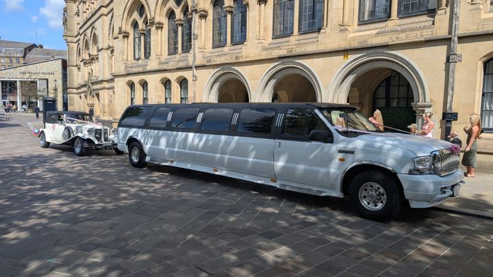 Wedding limo and Beauford vintage car outside city hall, Bradford