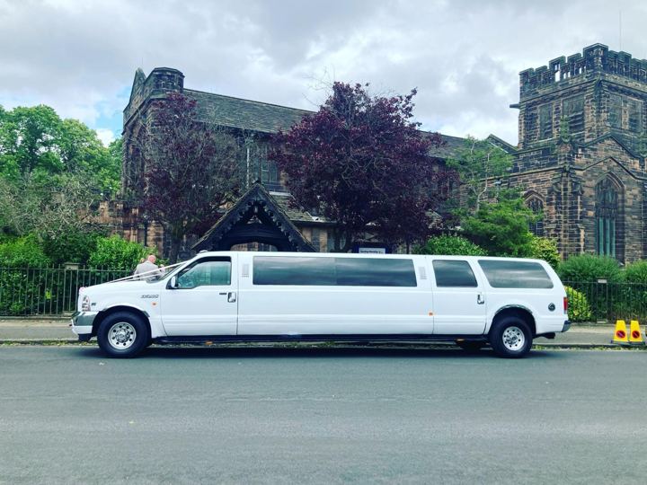 White Ford Excursion stretch limo outside a church, Coventry