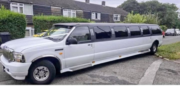 White Ford Excursion stretch limo side view, Huddersfield