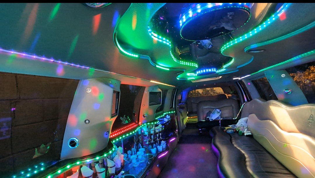 Stretch limo interior with LED party lighting, drinks bar and leather seating - City Limo Bradford